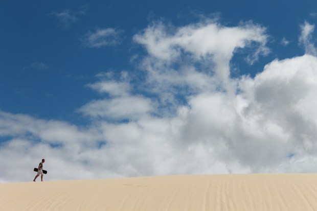 Climbing up the hill to sandboard